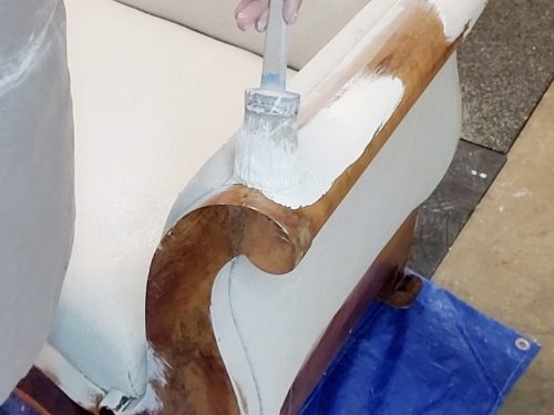 Painting the wood of this antique sofa.