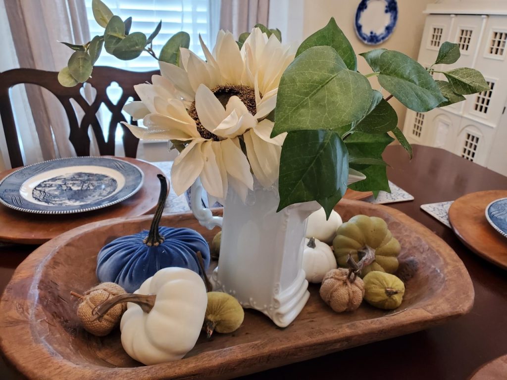 Layering small burlap, white, and sage green pumpkins into the dough bowl as I set the table for the fall season.