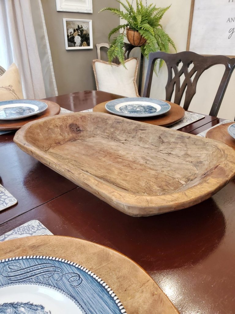 Adding a dough bowl to the center of the table as I set the table for the fall season.
