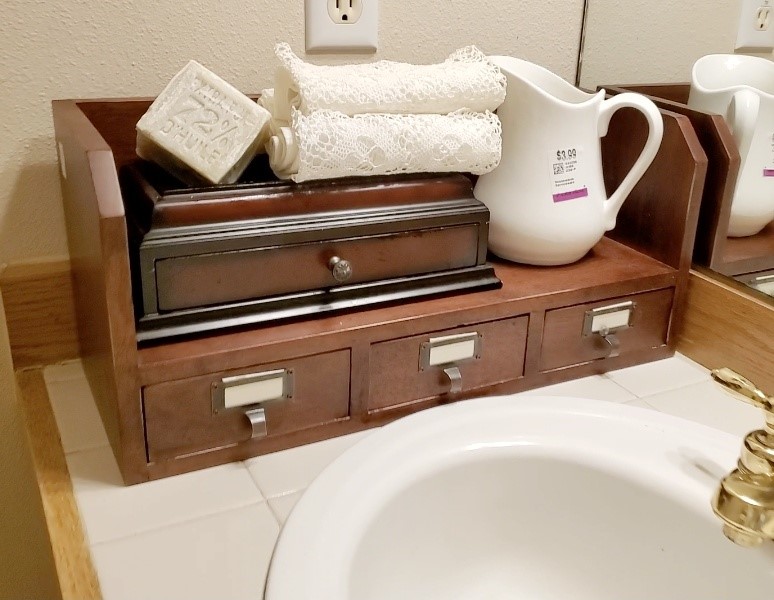 Jewelry box and wooden shelf placed together in our guest bathroom. Both were found at Goodwill for cheap.