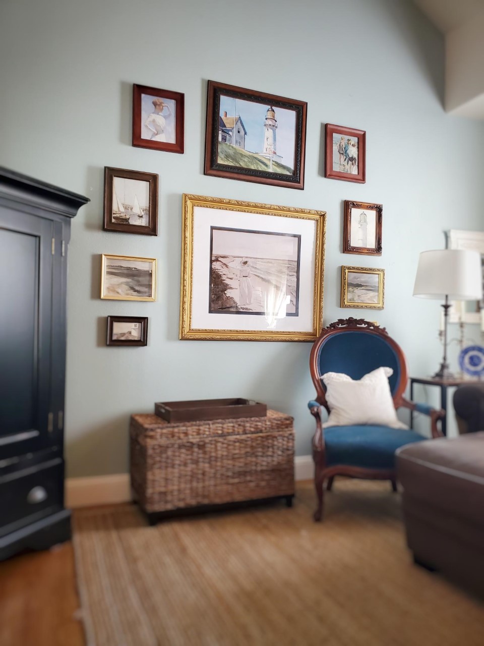 Gallery wall with blue prints that match the home decor of the living room.