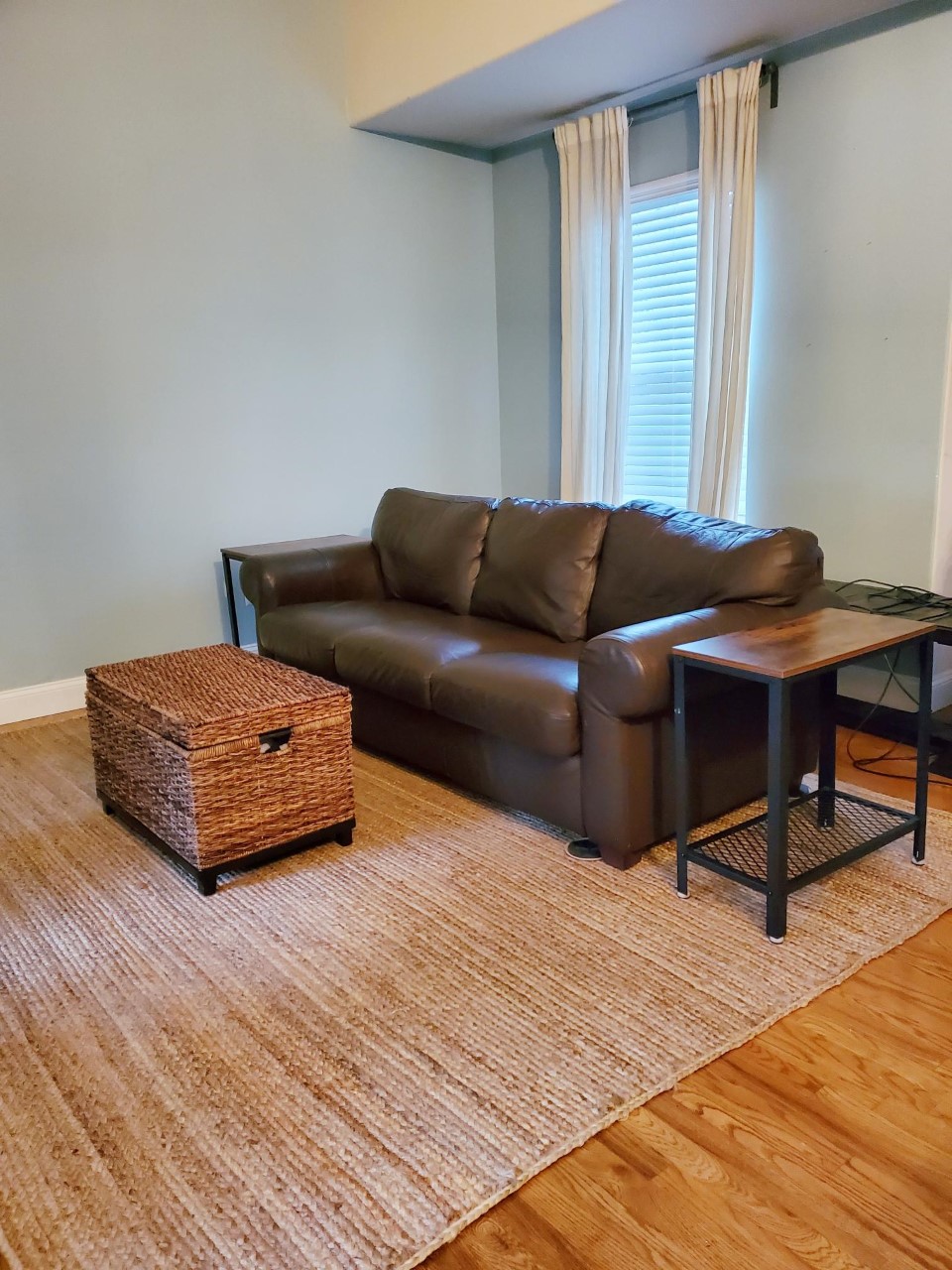 Jute rug placement in living room.