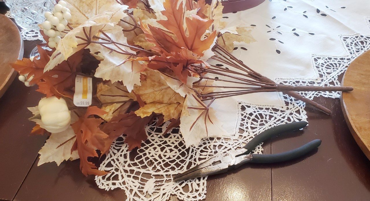 Faux leaves with pumpkins that will be added to the fall centerpieces.