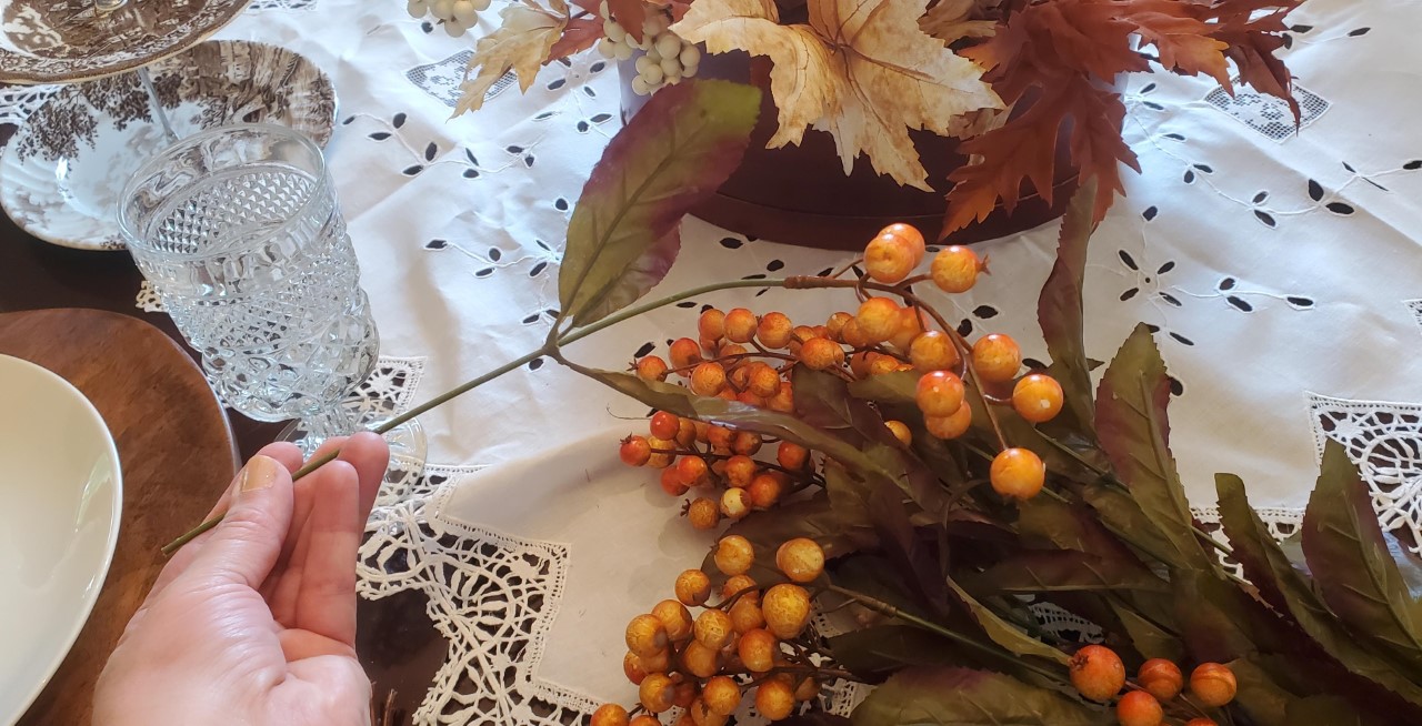 Faux berries that are added to the fall centerpiece