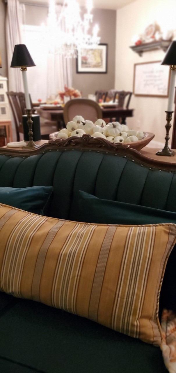 Mustard yellow pillow on a green Victorian antique sofa. Fall decor. Fall pillow.