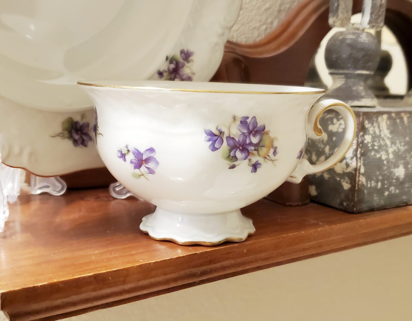 Up close photo of a purple floral teacup found at Goodwill.