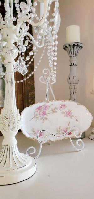 Pink floral oval bowl on a plate stand.