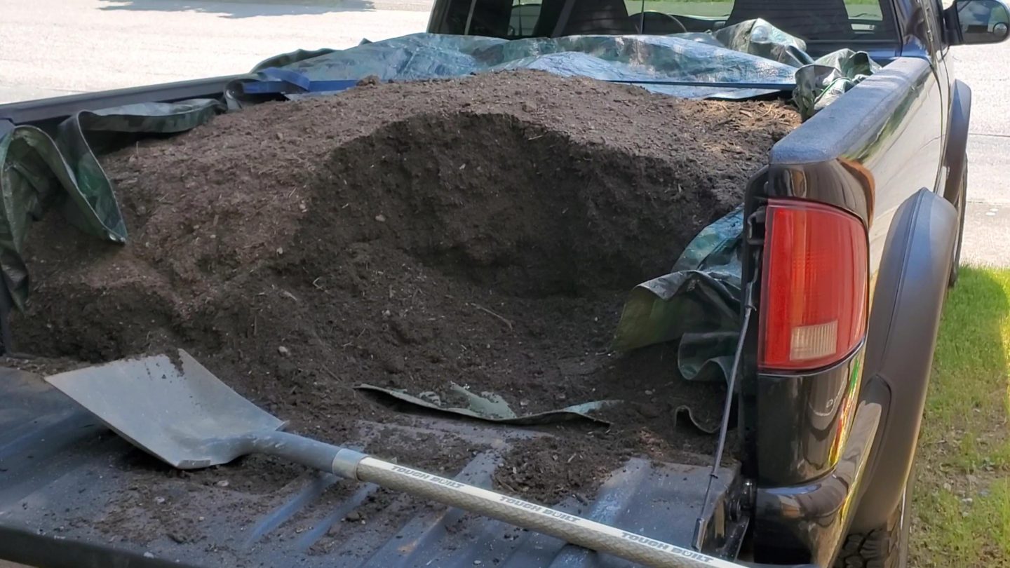 Pick up truck filled with garden soil.