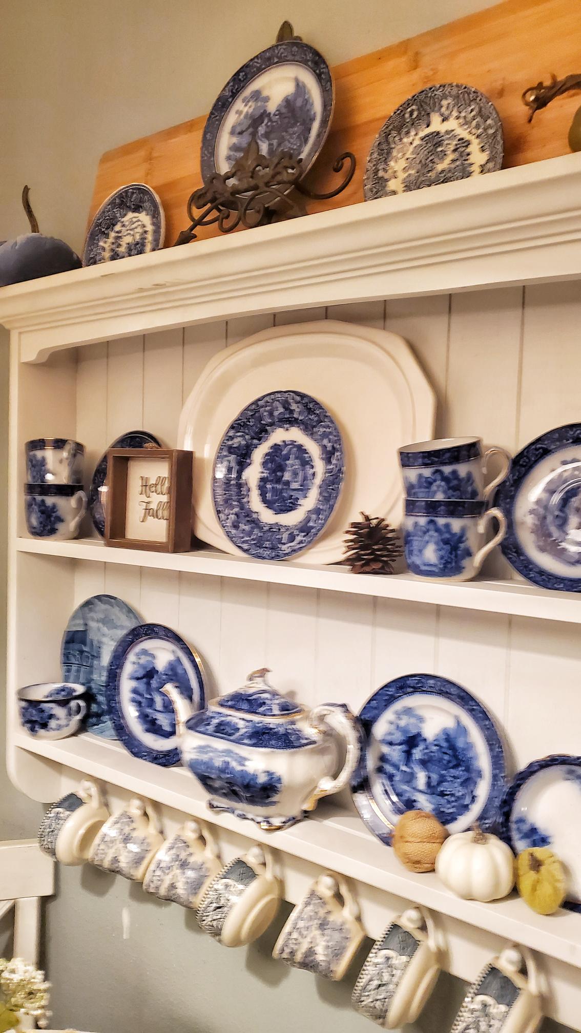 Flow blue dishes on a wall shelf. Fall touches added to dishes shelf.