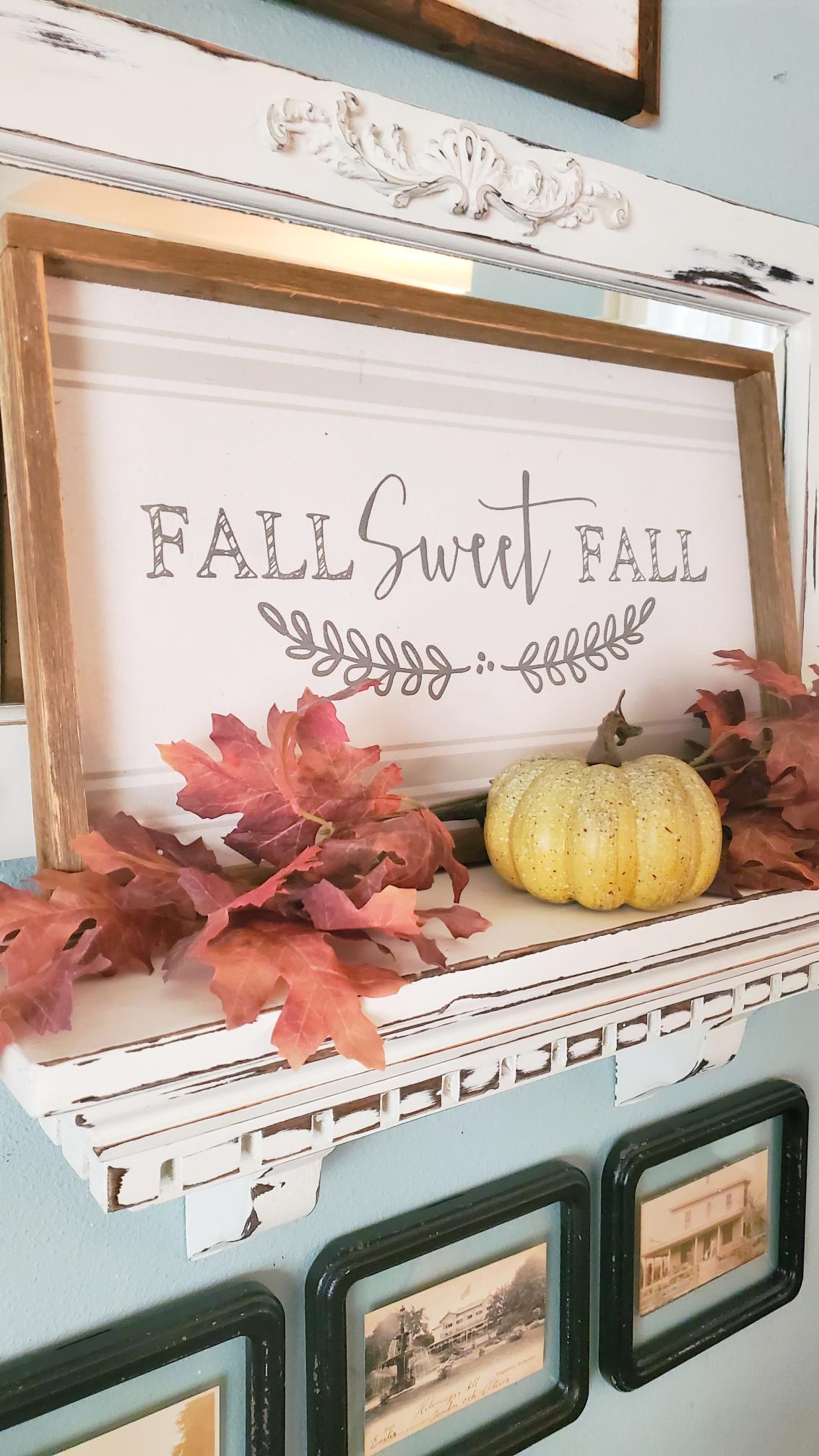 Fall Sweet Fall sign on top of a shelf displayed on our gallery wall.