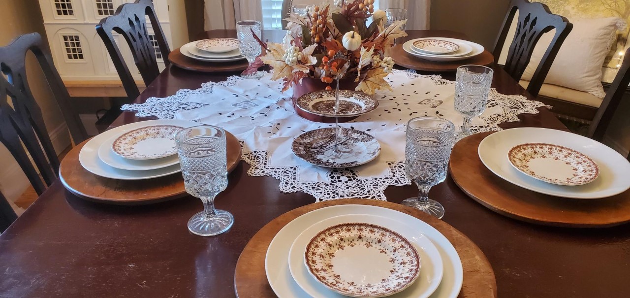 Dining room table set with fall decor.