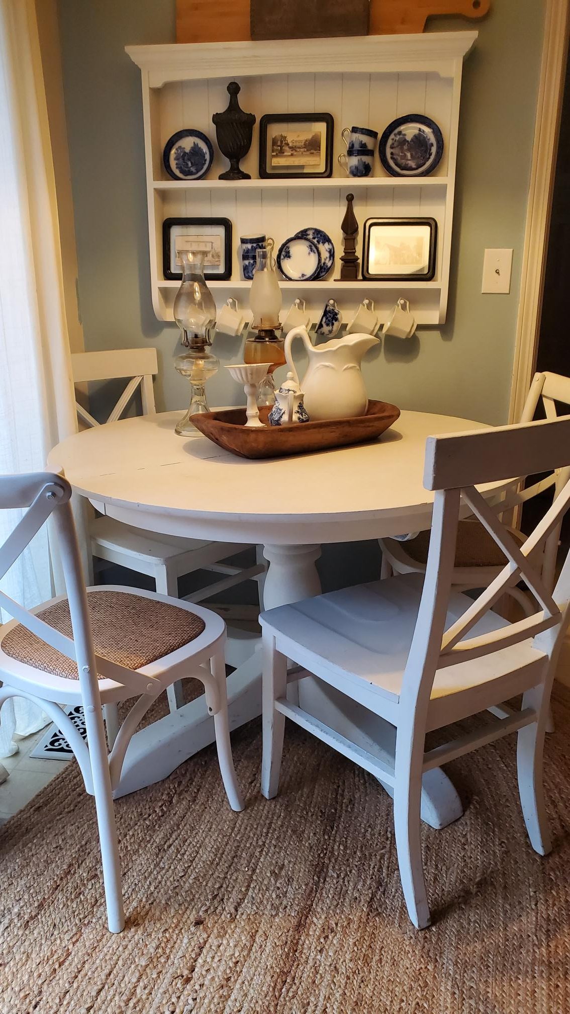 Breakfast nook. Round white table with 4 chairs.